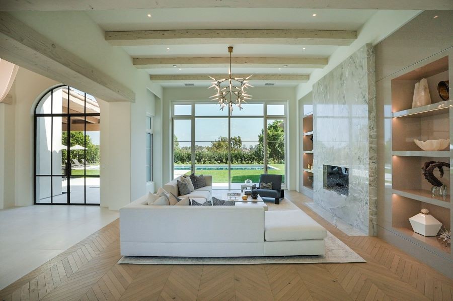 Sonance Invisible speakers in a living room with windows looking out over the pool.