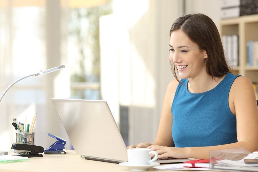 A woman using her laptop with a consistent home network connection.
