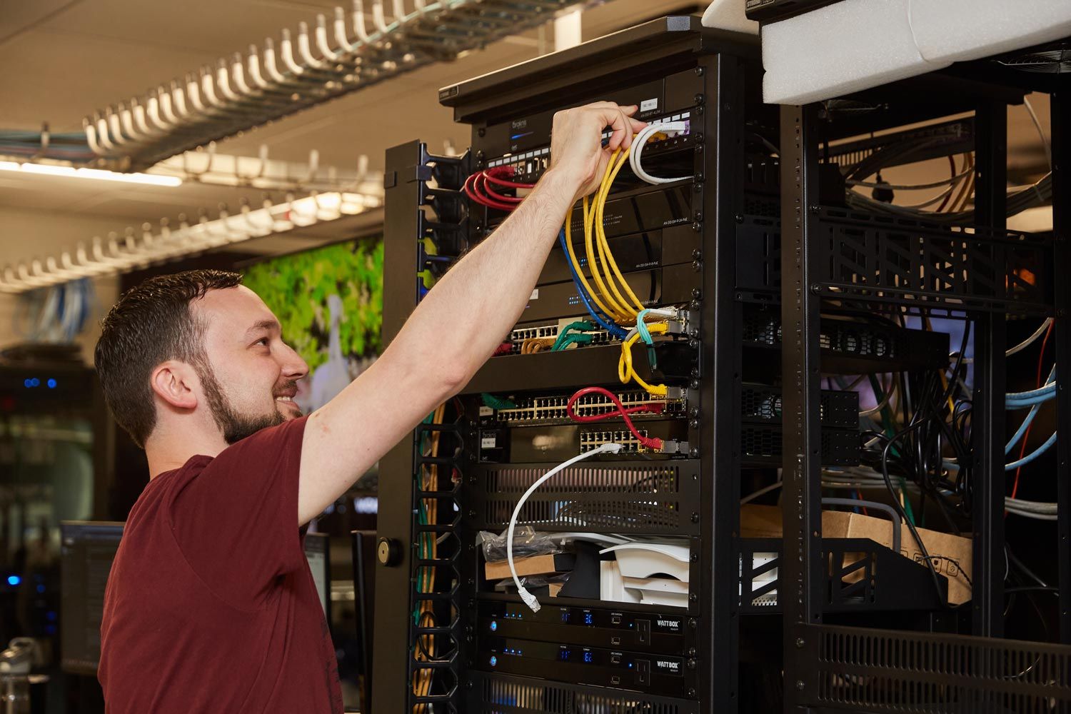 Person unplugging cable from server